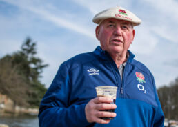 Mature England Rugby fan holding pint of Guinness