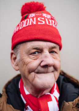 Elderly Wales rugby fan bobble hat and scarf